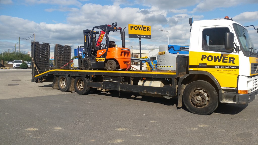 Rental forklift being delivered on a lorry