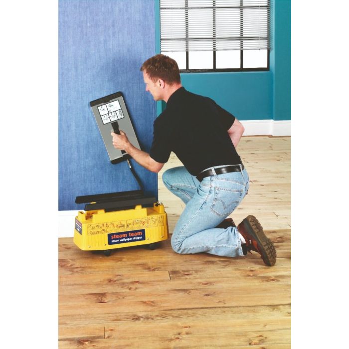 Man using a wallpaper stripper