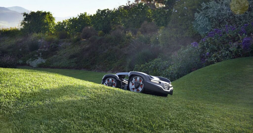 A Husqvarna Automower on a lawn slope